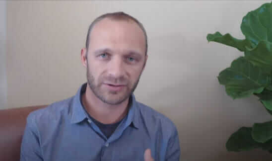 Lakota Denton sitting in office wearing blue shirt