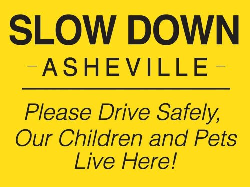 Yellow Slow Down Asheville Campaign Sign with the phrase "Please Drive Safely Our Children and Pets Live Here"